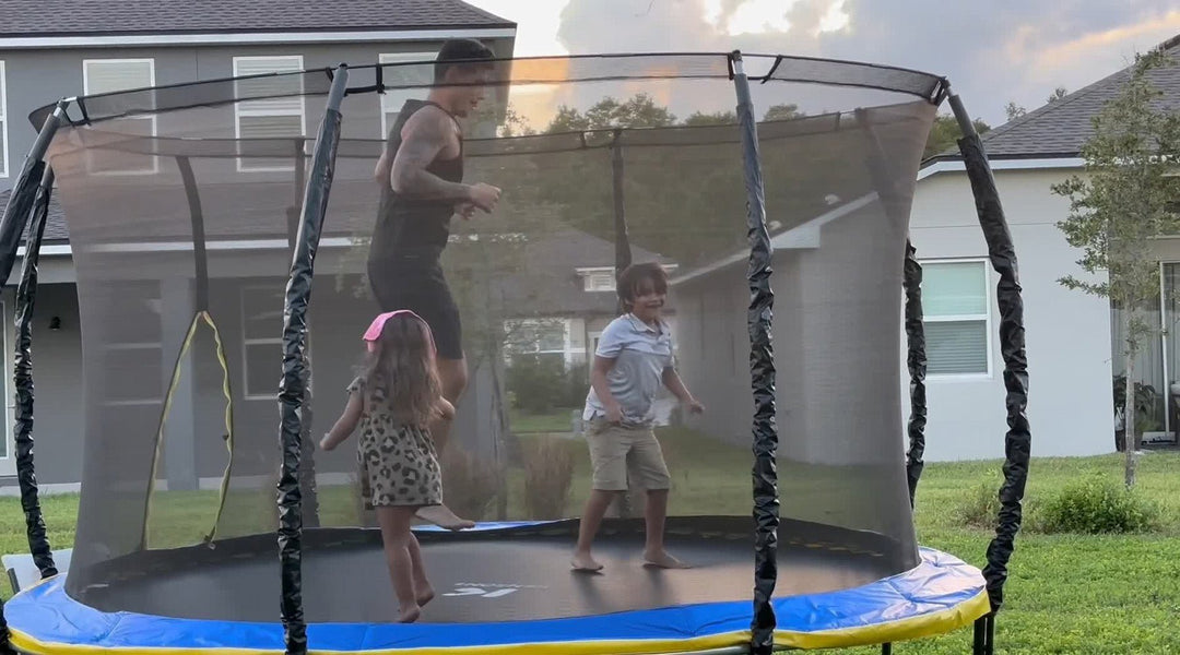 two-kids-playing-on-trampoline-with-dad