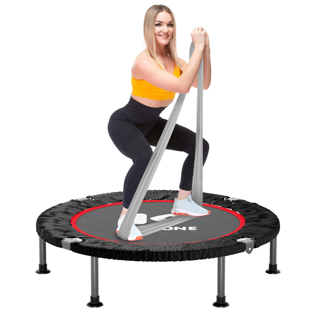 A person exercising on a 40-inch mini trampoline with a pink and black color scheme. The trampoline has a steel frame, and a black mat.