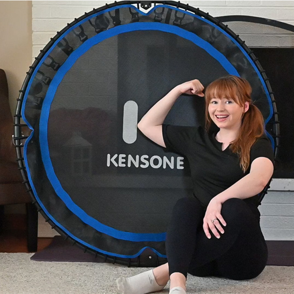 Woman posing with a KENSONE rebounder in a home setting