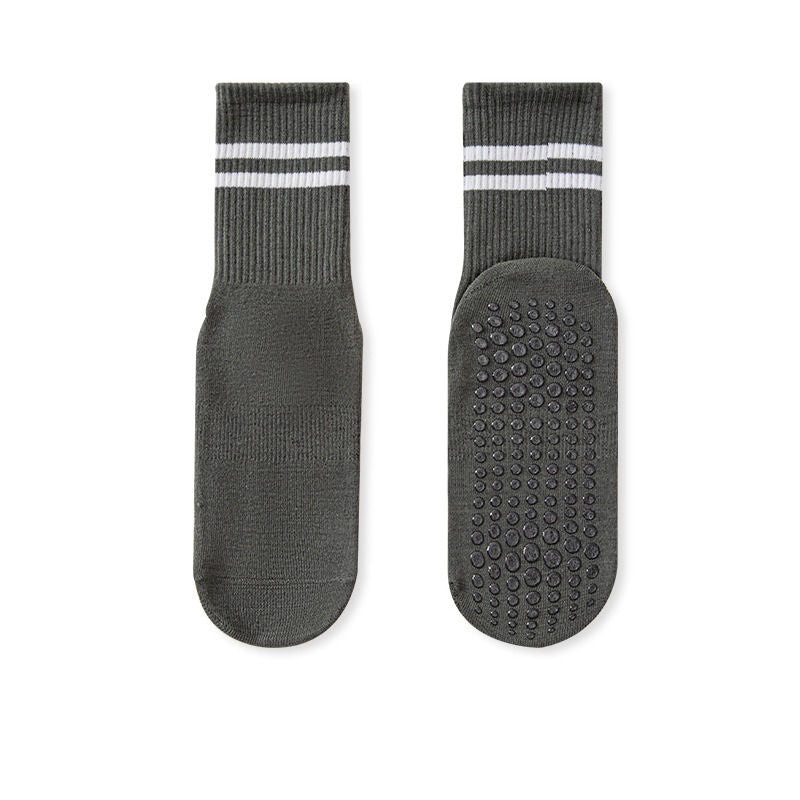 A pair of no-slip grip tall socks with a striped design and textured sole.