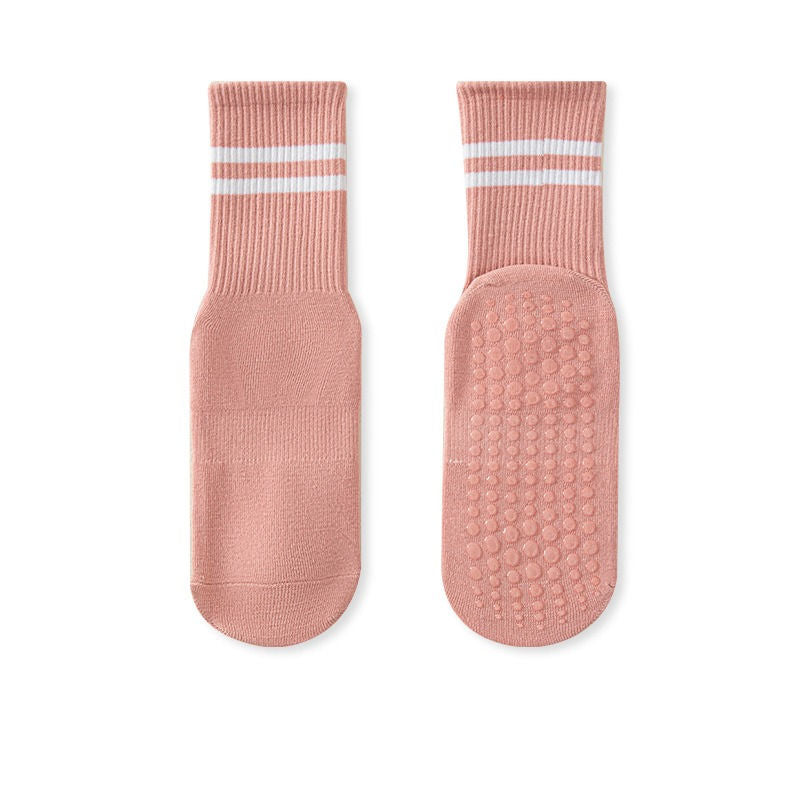 A pair of pink no-slip grip tall socks with non-slip soles, displayed against a white background.