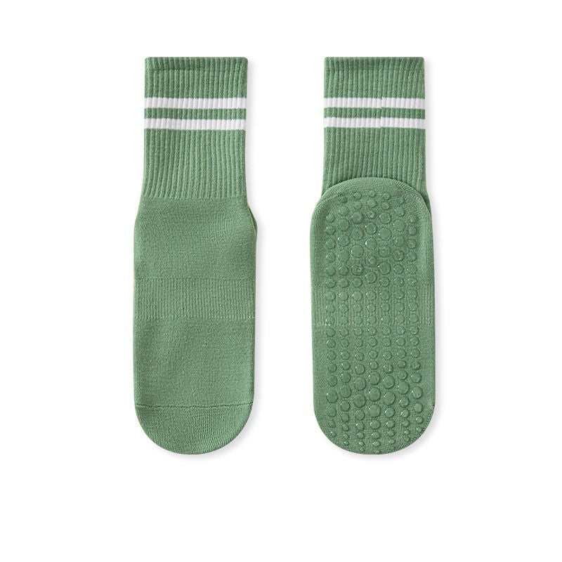 A pair of green no-slip grip tall socks with a striped pattern on the ankle area.