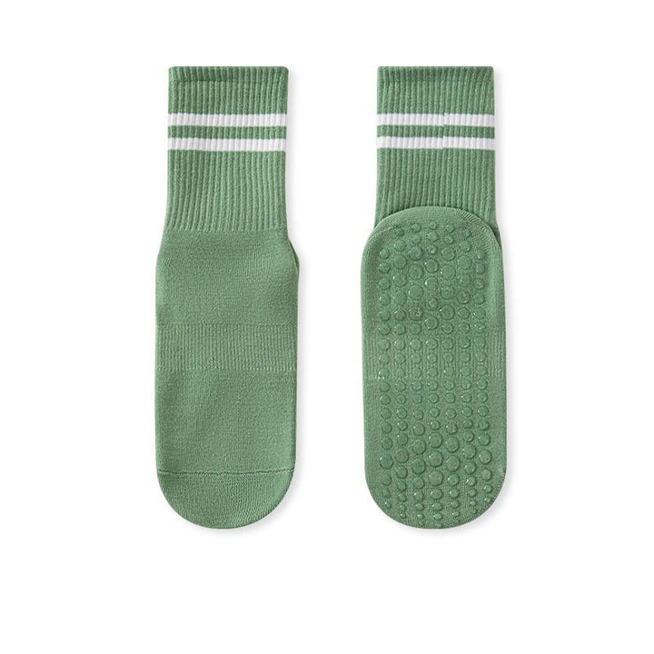 A pair of green no-slip grip tall socks with a striped pattern on the ankle area.
