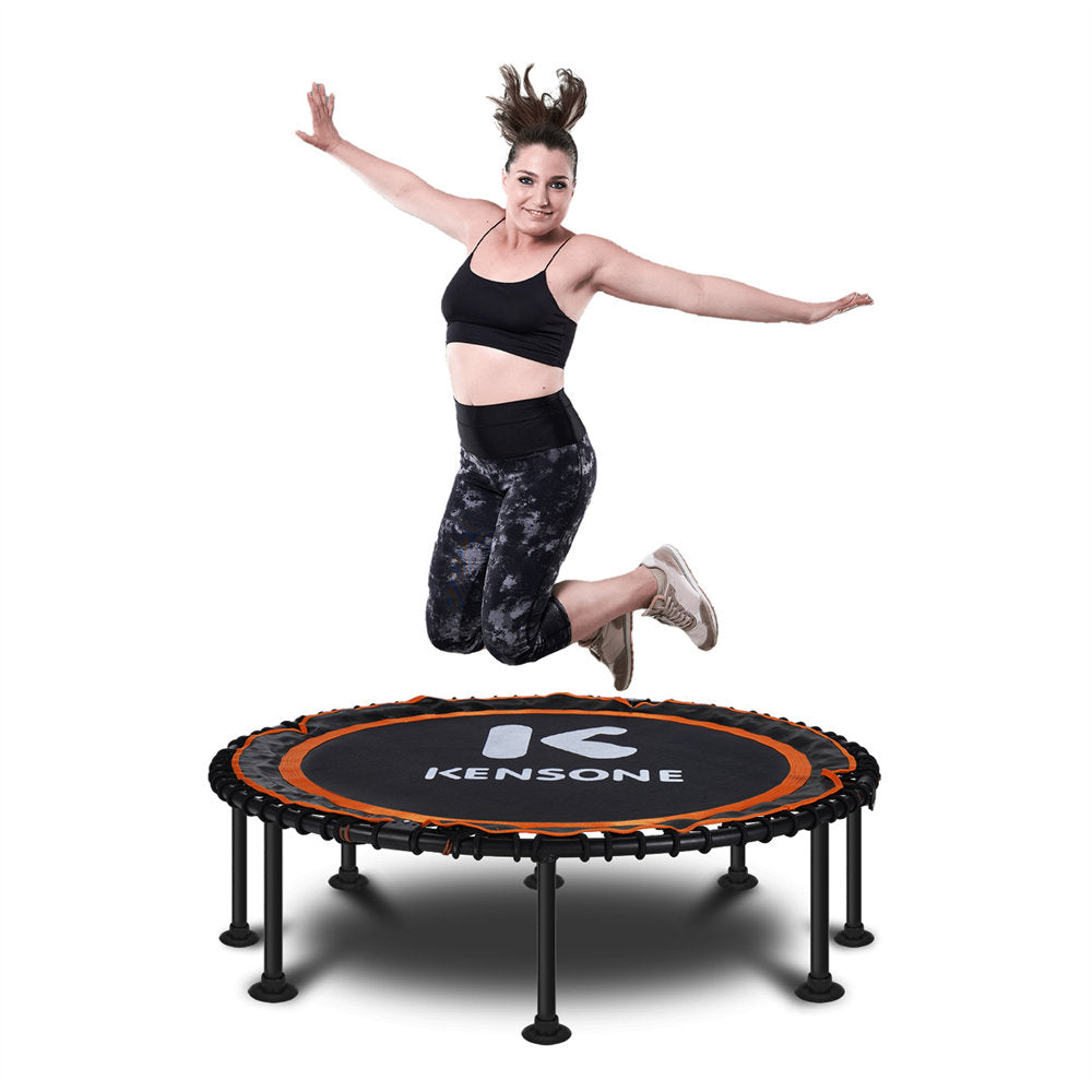 Woman jumping on a Kensone orange bungee trampoline with a white background
