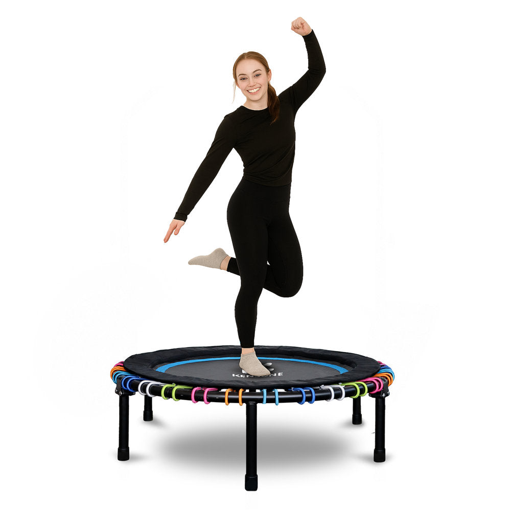 Woman jumping on a small trampoline with colorful bungees a white background