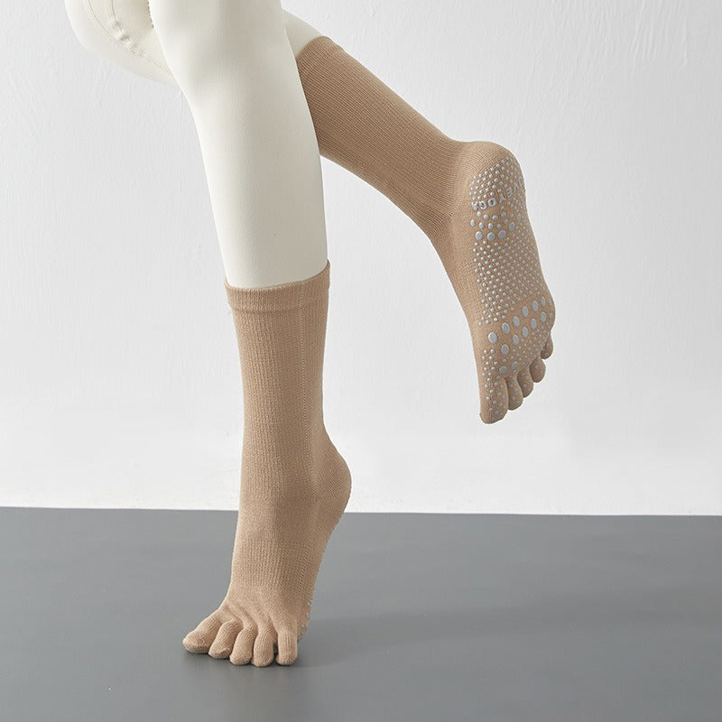 Beige socks with toe separation on a plain background